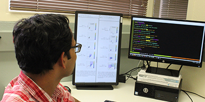 photo: student facing a computer screen displaying programming code